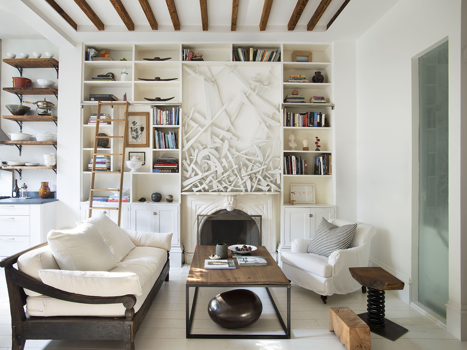 living room with white furniture and ceiling bookshelves