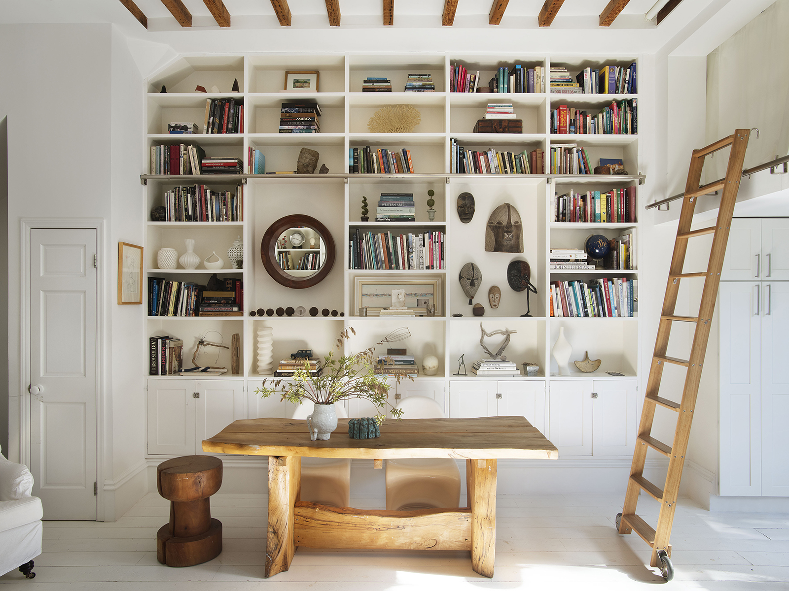 Kitchen table with ladder leading to sleeping nook