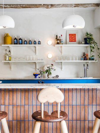 Bar counter with blue grout and custom barstools