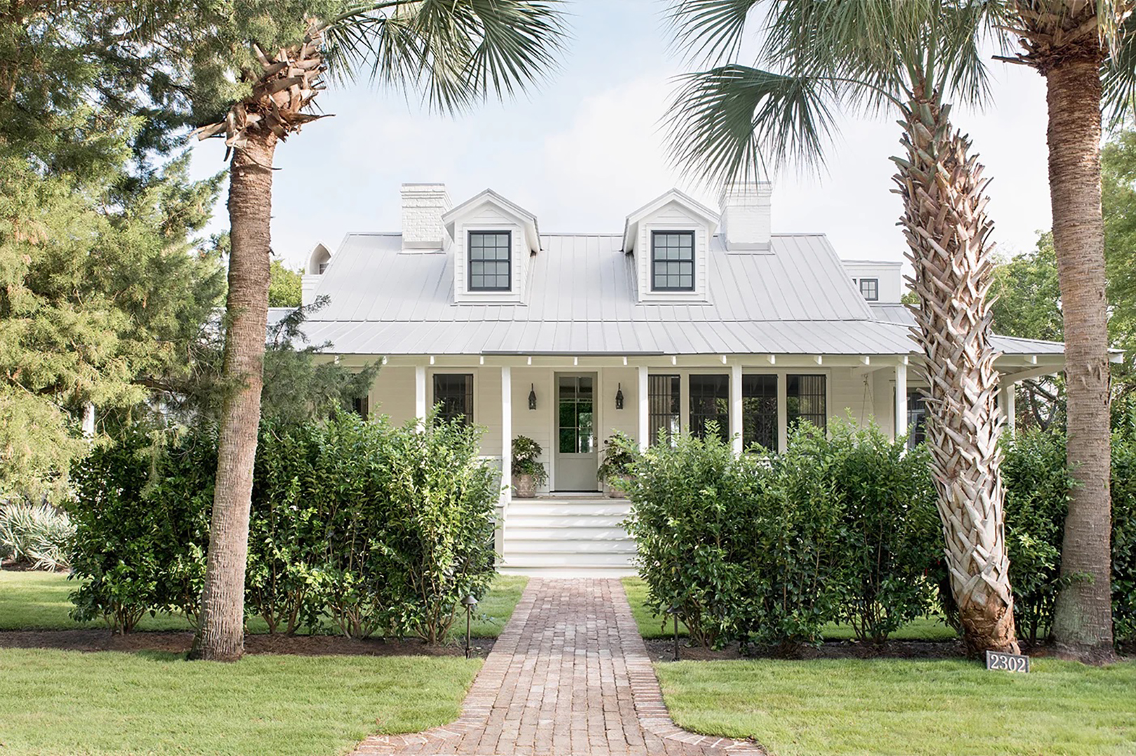 white bungalow with palm trees