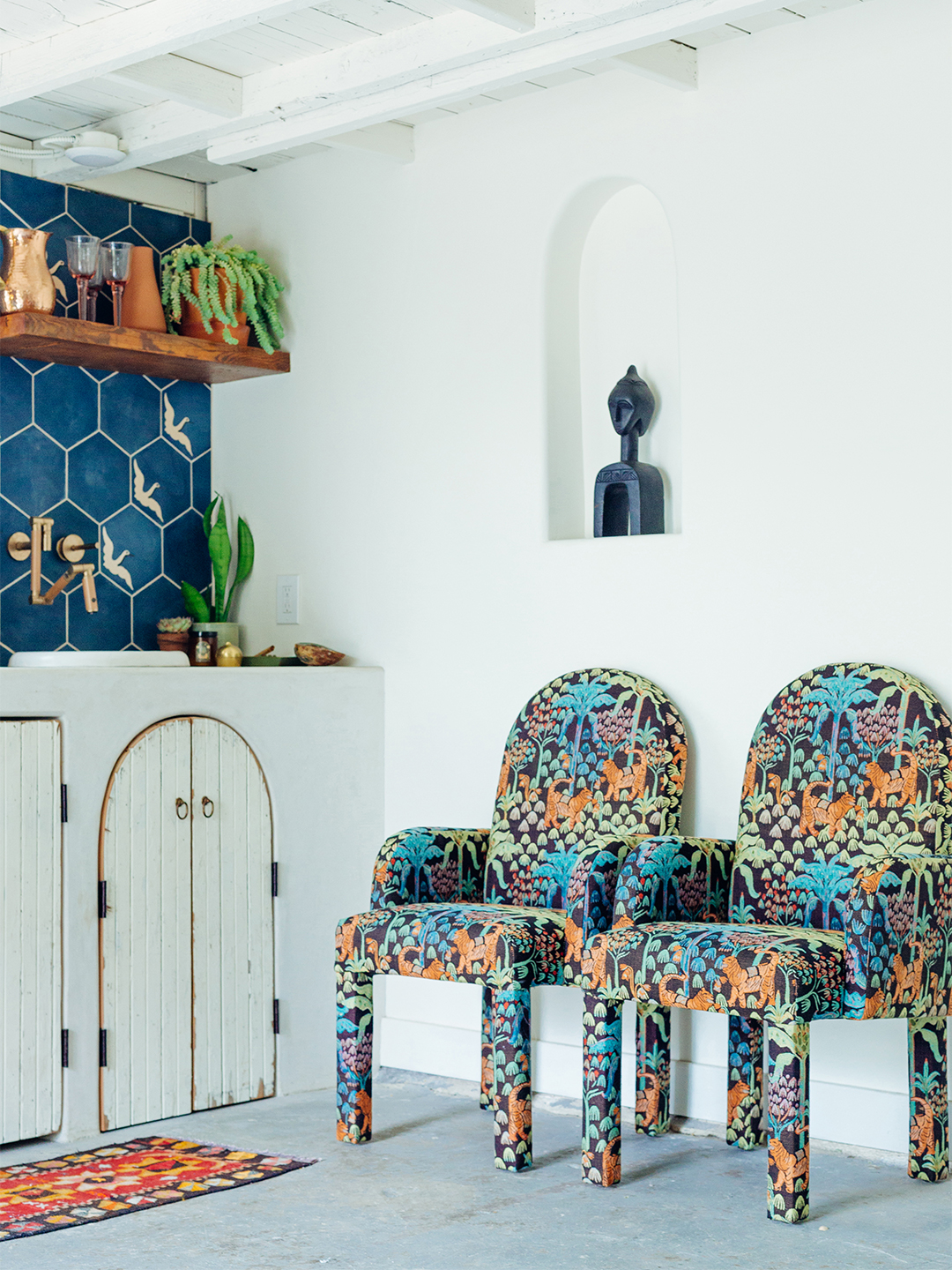 Patterned chairs next to a sink