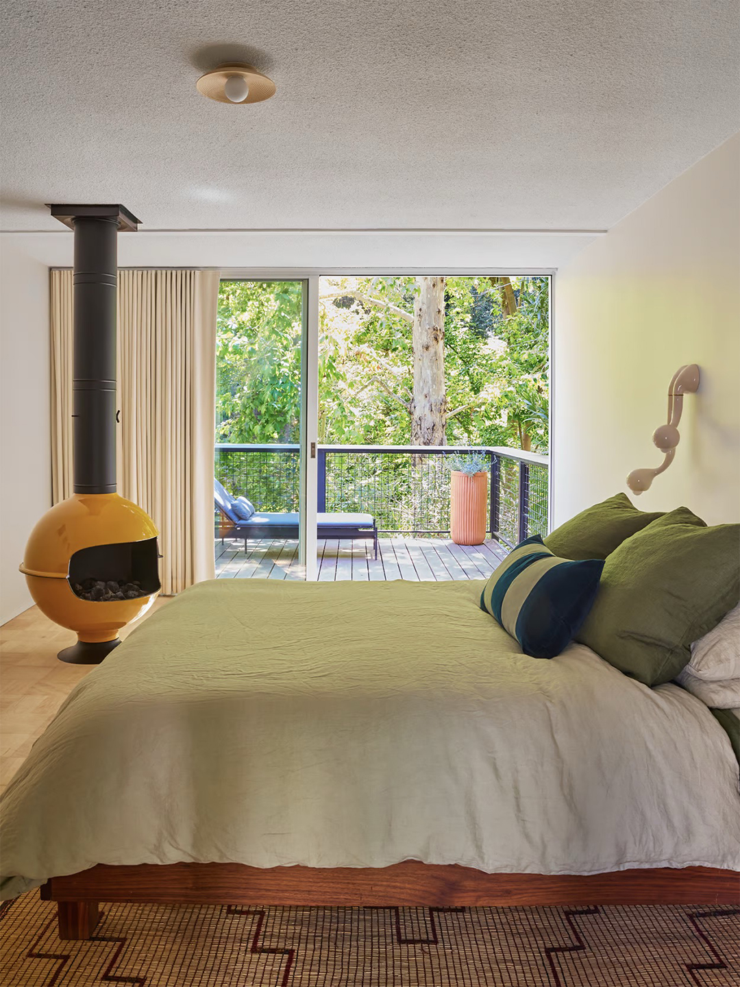 Bedroom with yellow fireplace.