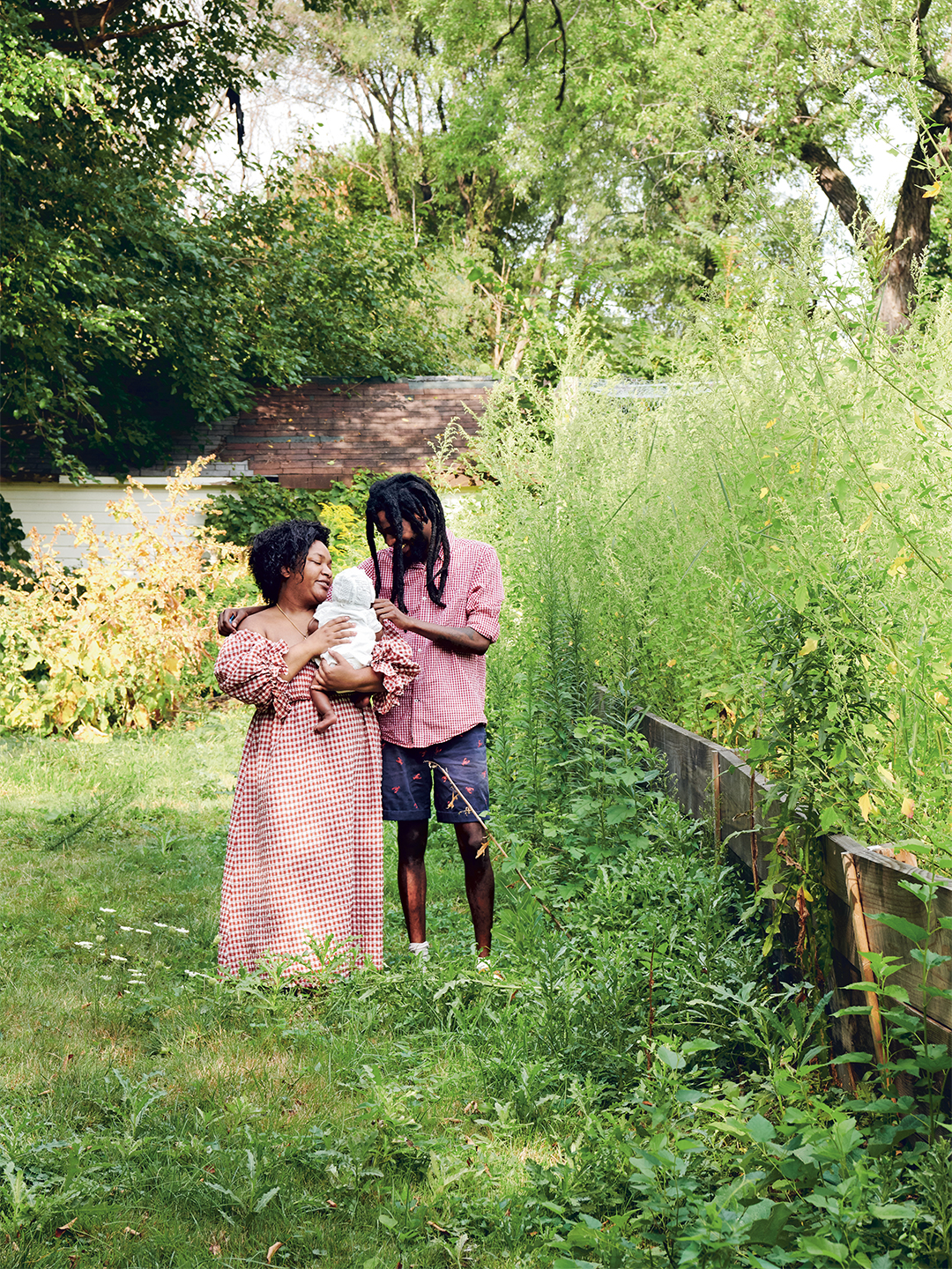 Couple holding baby outdoors