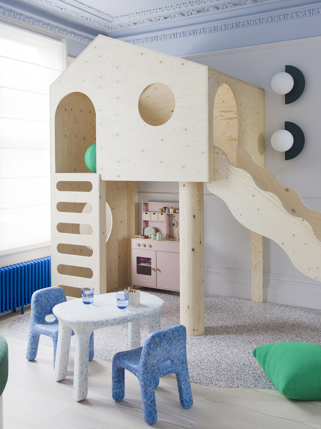 Birch wood play structure with slide in kids' playroom.