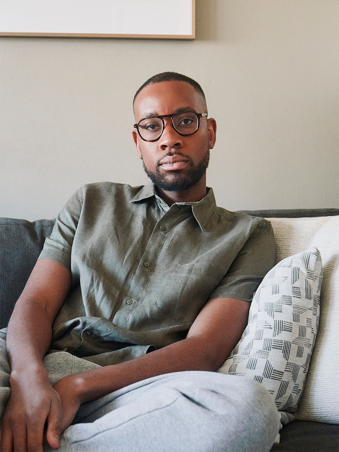 Man in green shirt on sofa