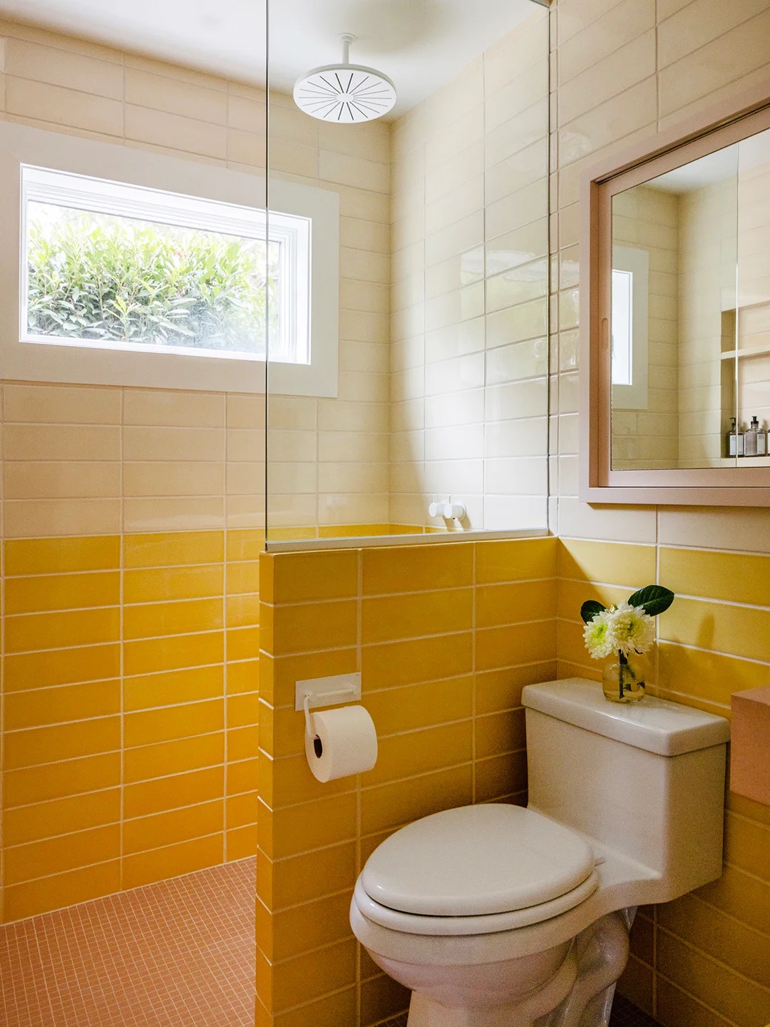 Sunny bathroom with two shades of yellow tiles.