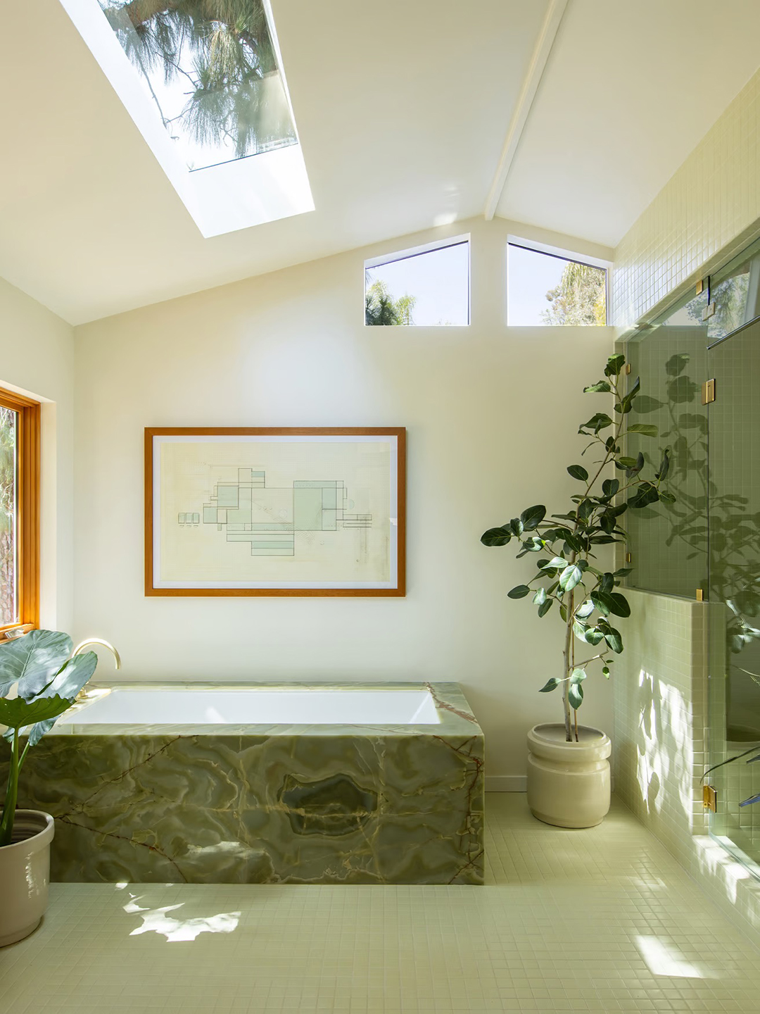 Bright bathroom with jade bathtub and skylight.