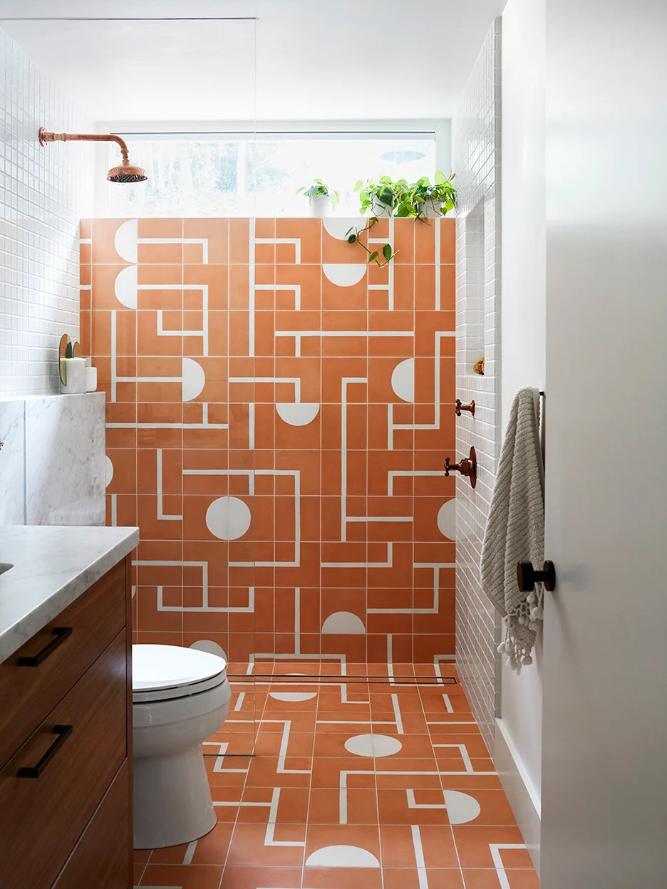 Bathroom with terracotta- and white-colored geometric tiles.