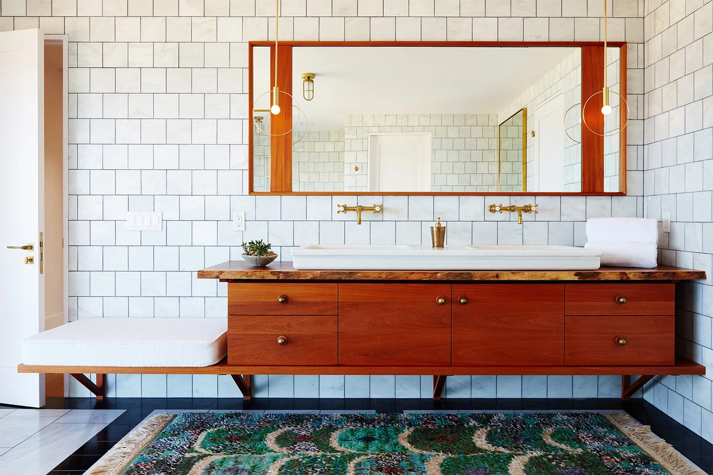 Bathroom with wood vanity and seat.