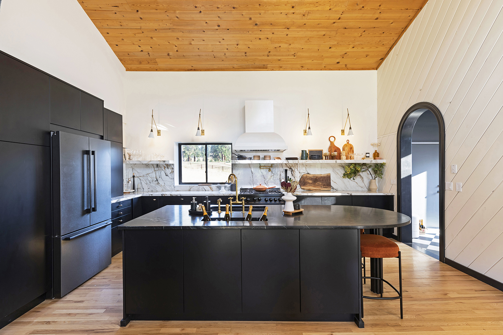 Kitchen with black counters and champagne sink