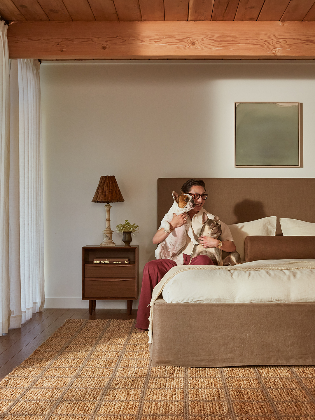 Man sitting on bed with dog