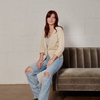 girl sitting on edge of sofa