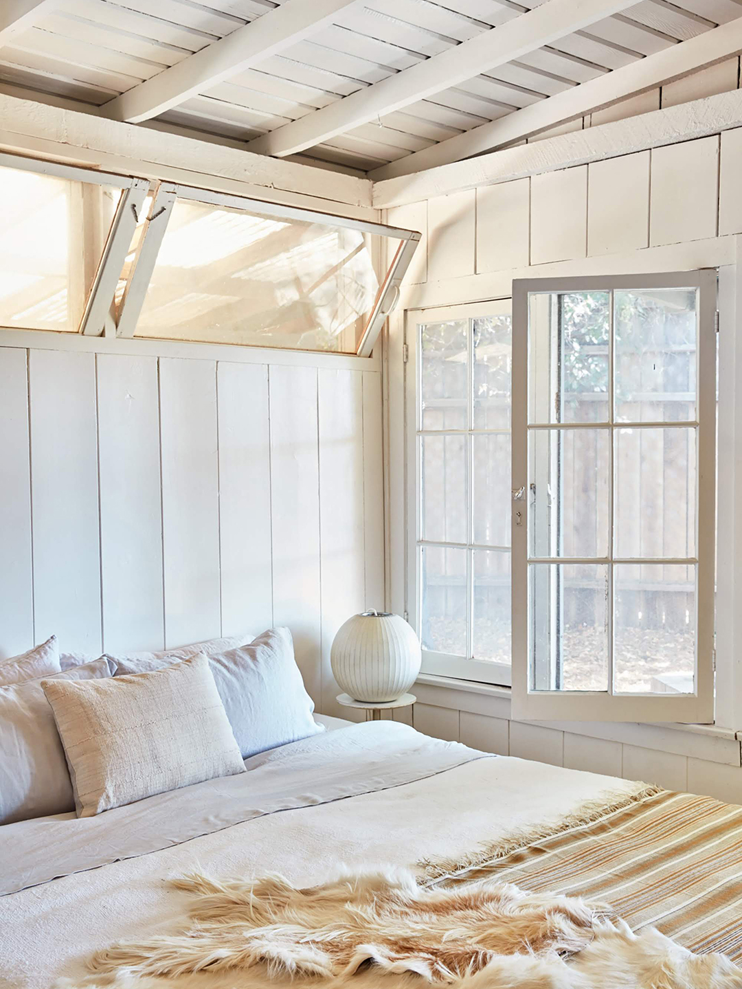 bright white bedroom with windows