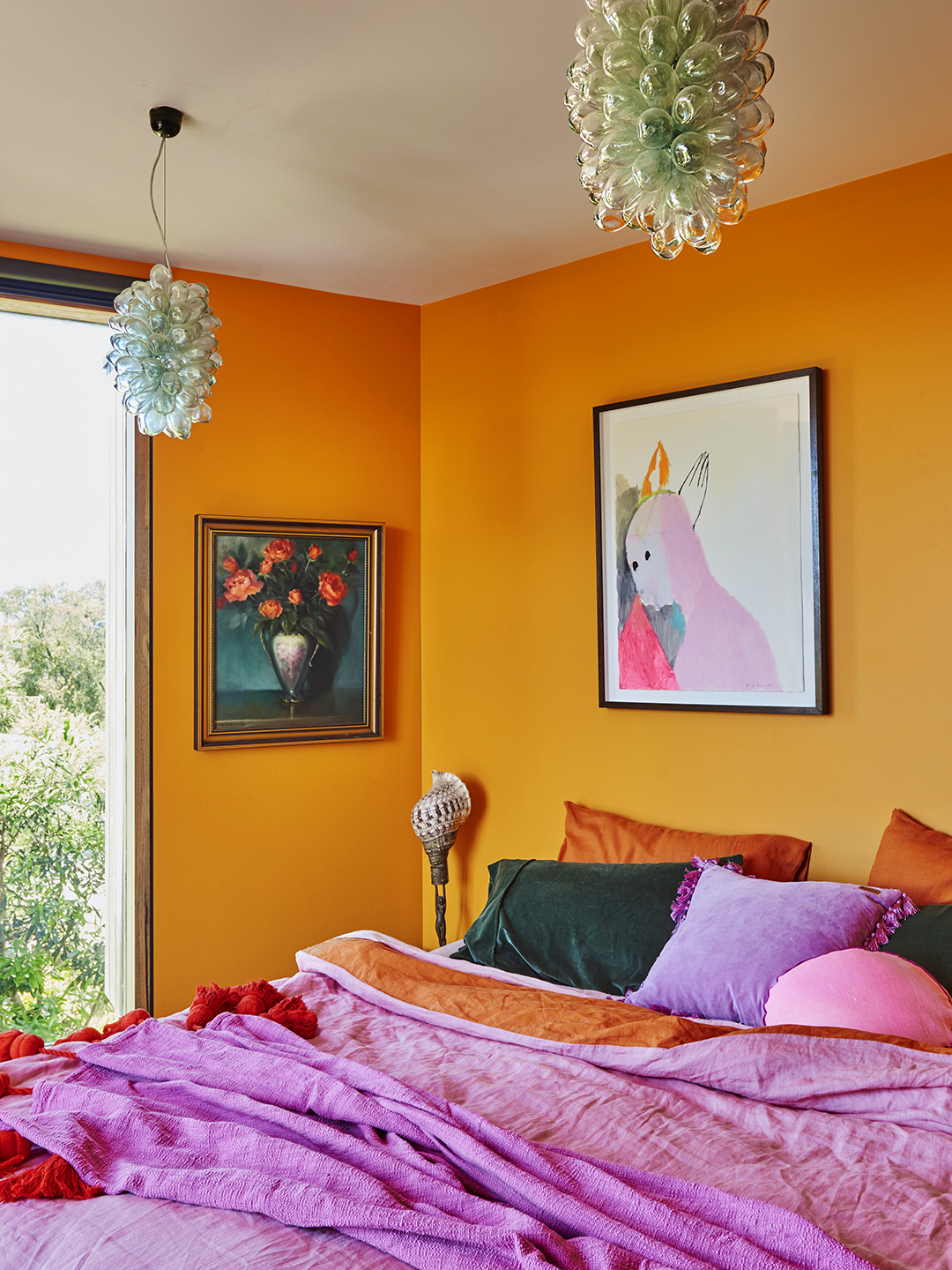 Bedroom with orange walls and magenta bedding