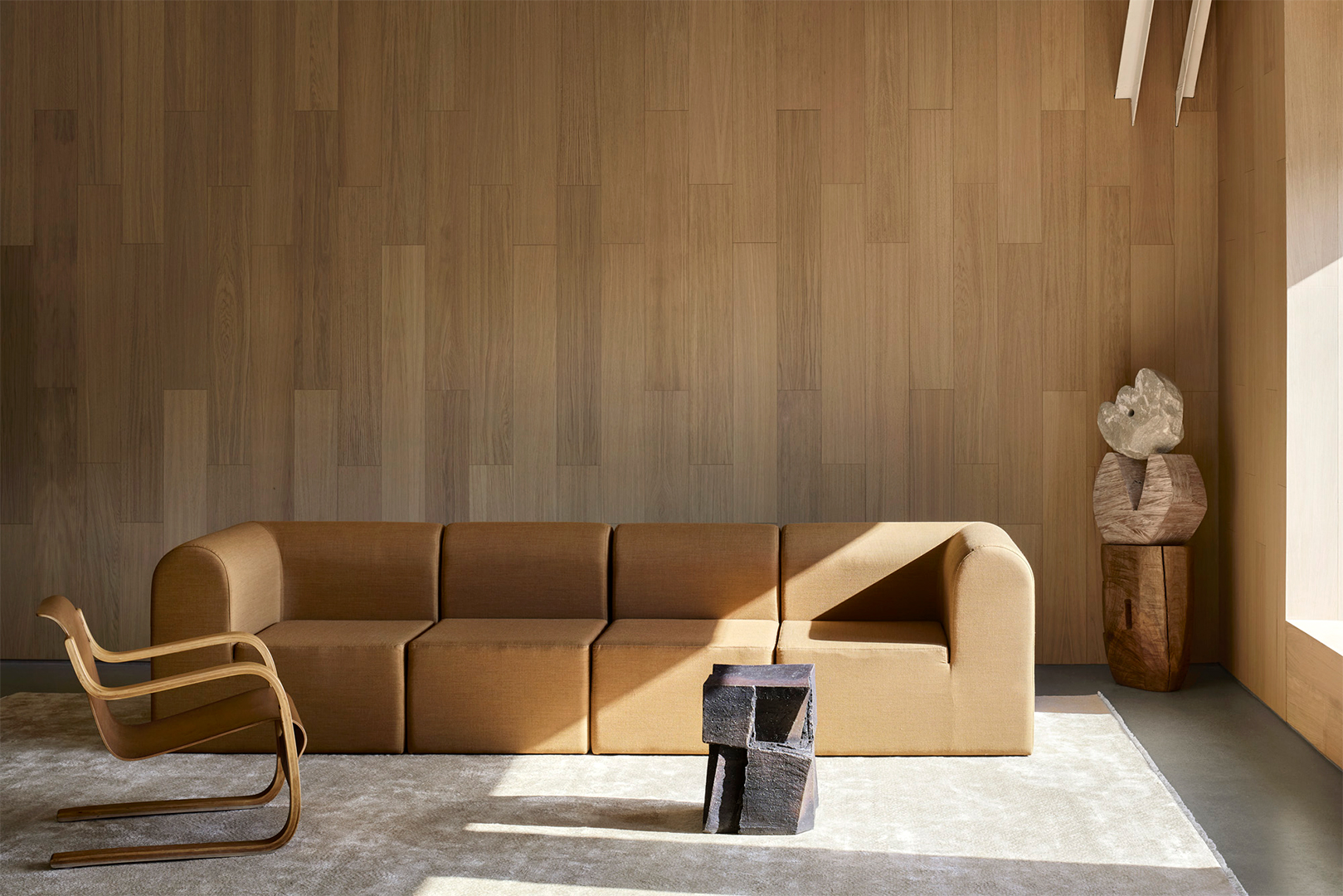 living room area with sofa and wood paneled walls