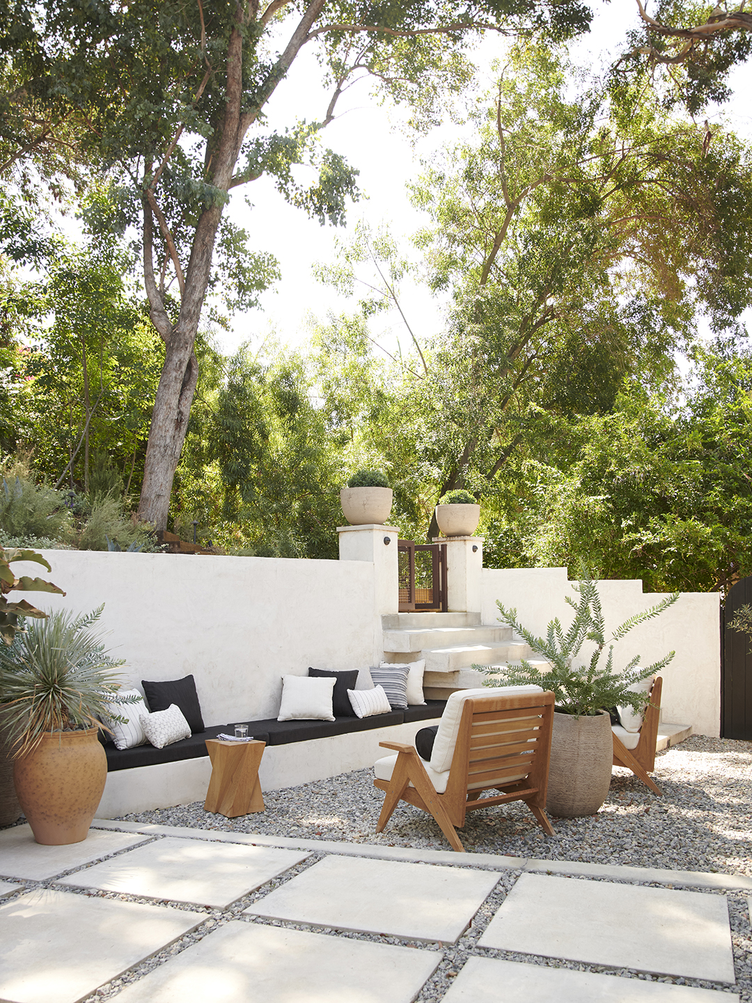 Sitting area in a backyard with potted plants