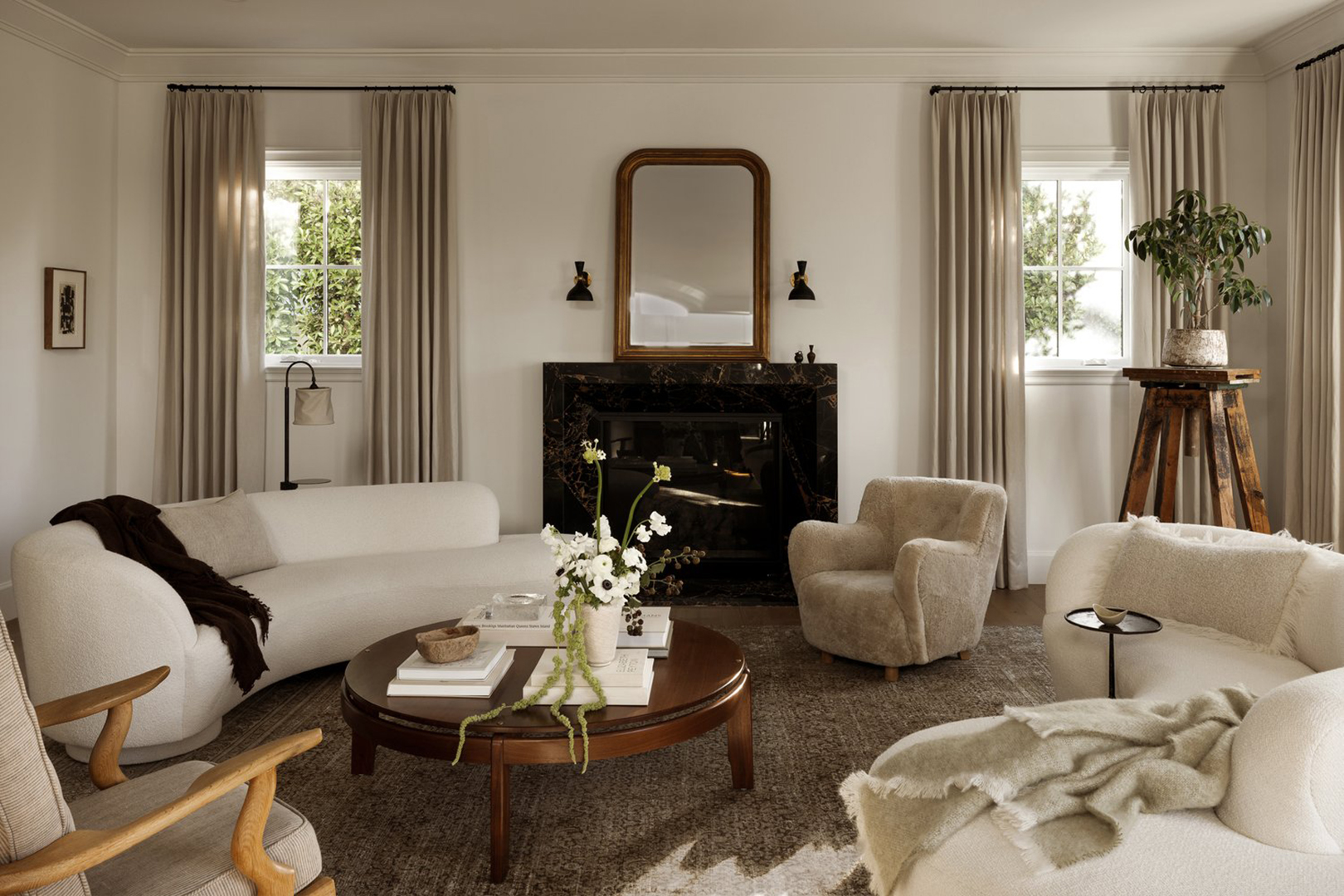 Living room with marble fireplace and white curved sofa