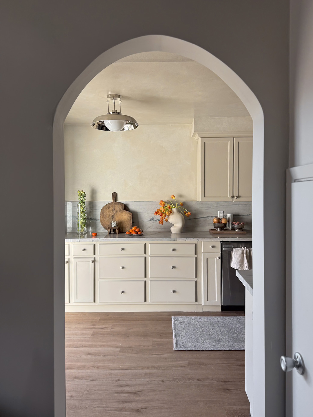 archway looking into lower cabinets