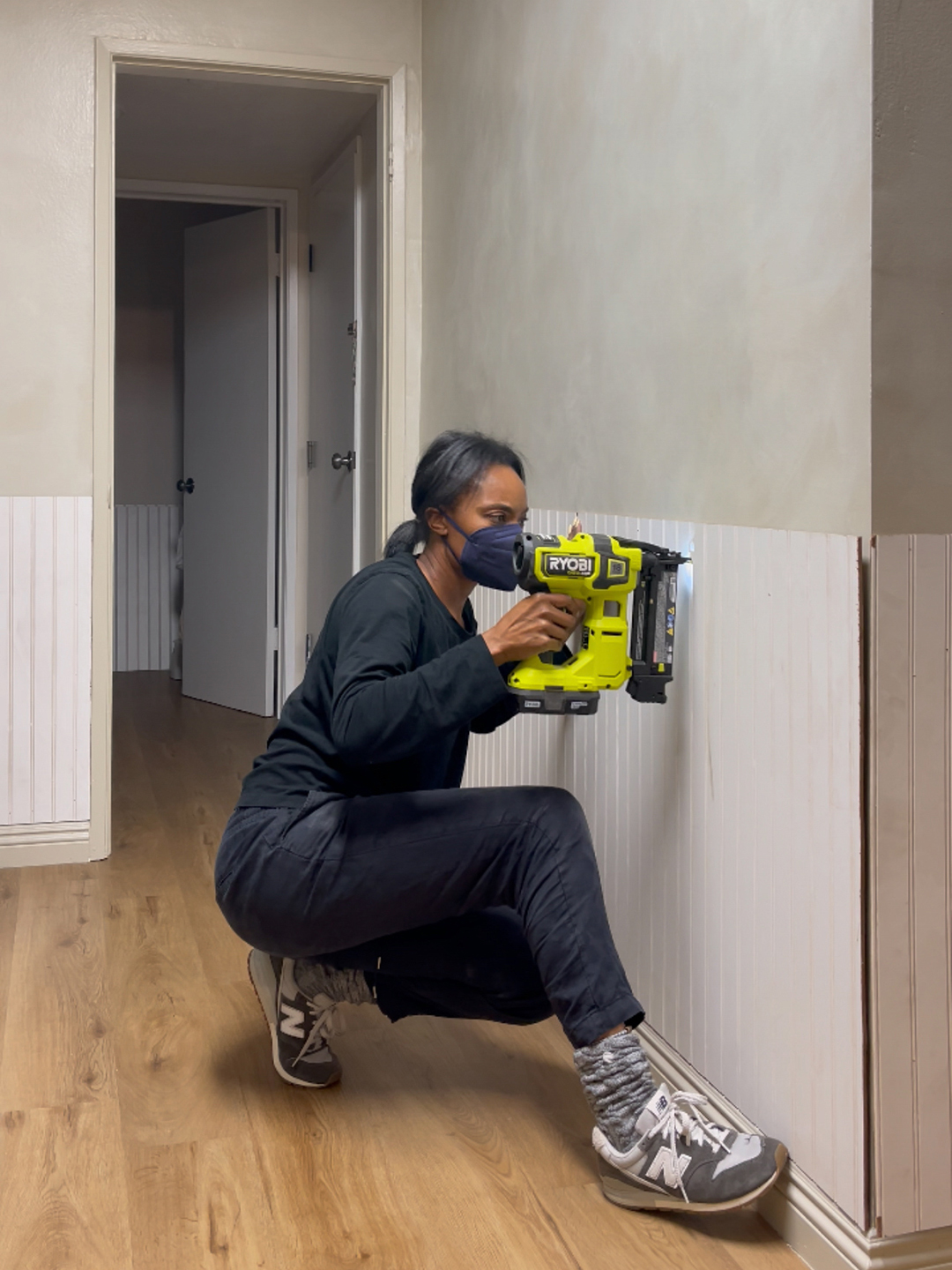 Woman nailing beadboard