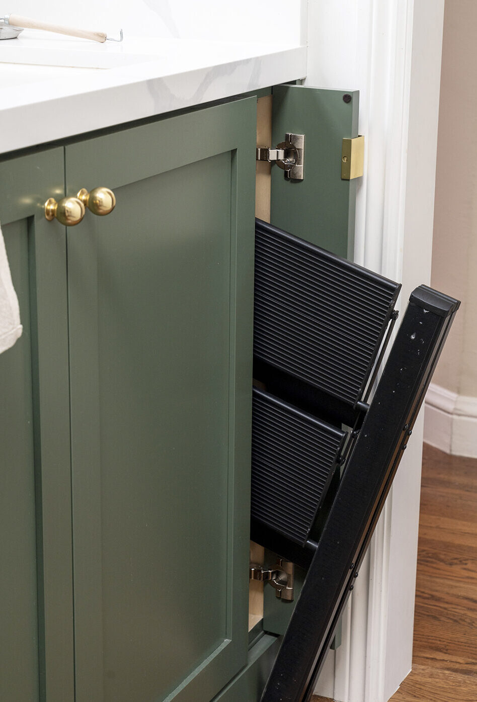 stool halfway out of cabinet