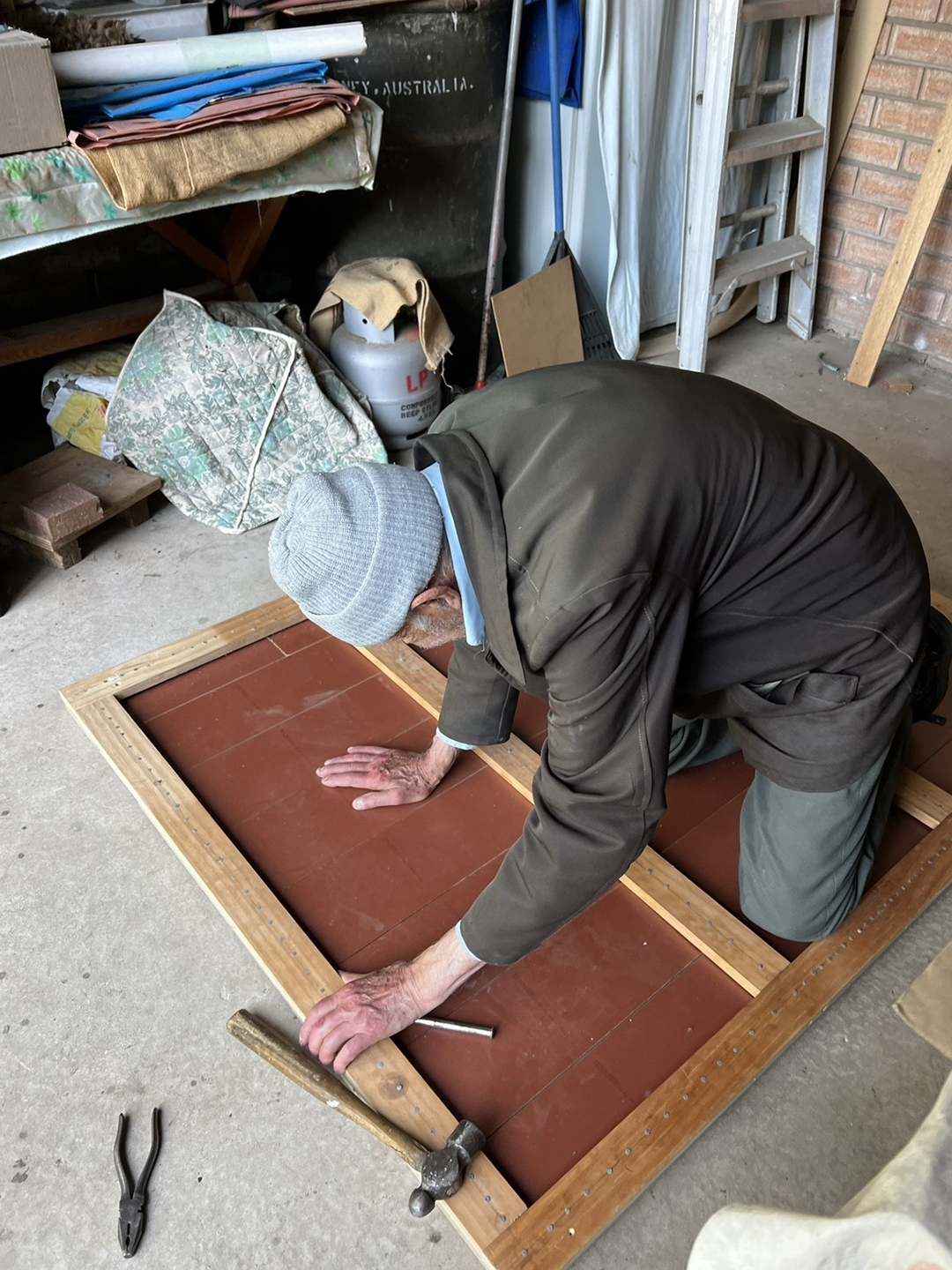 man sanding wood