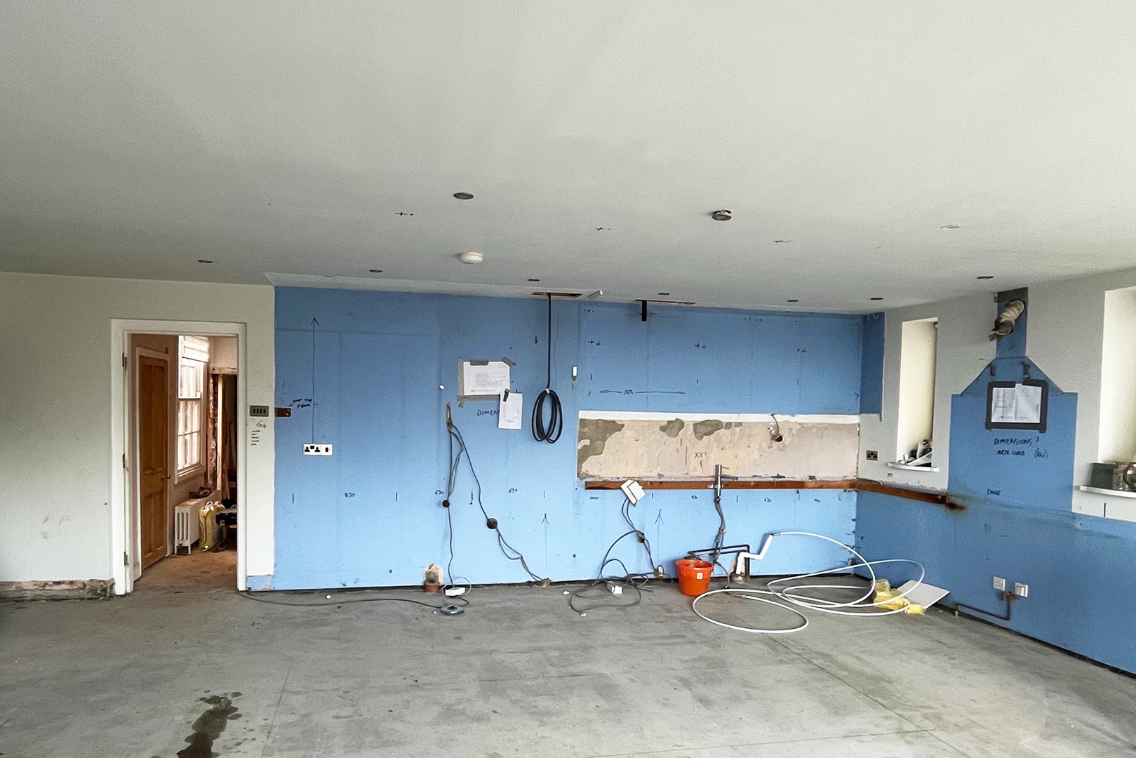 empty kitchen with blue walls mapped out