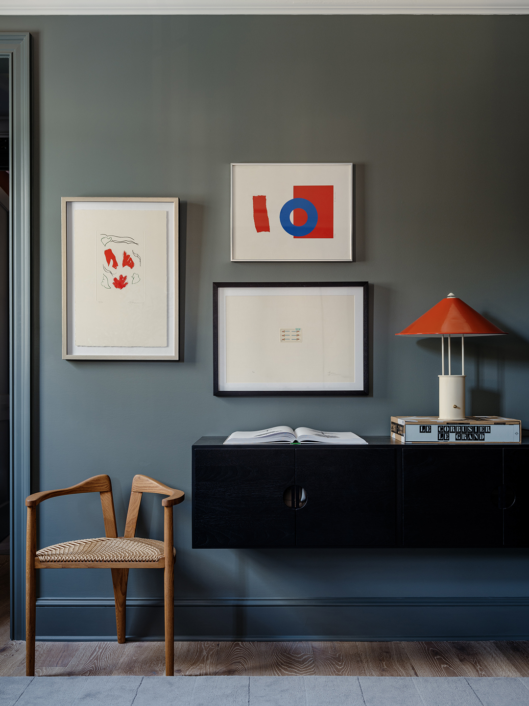 black floating credenza in blue hallway