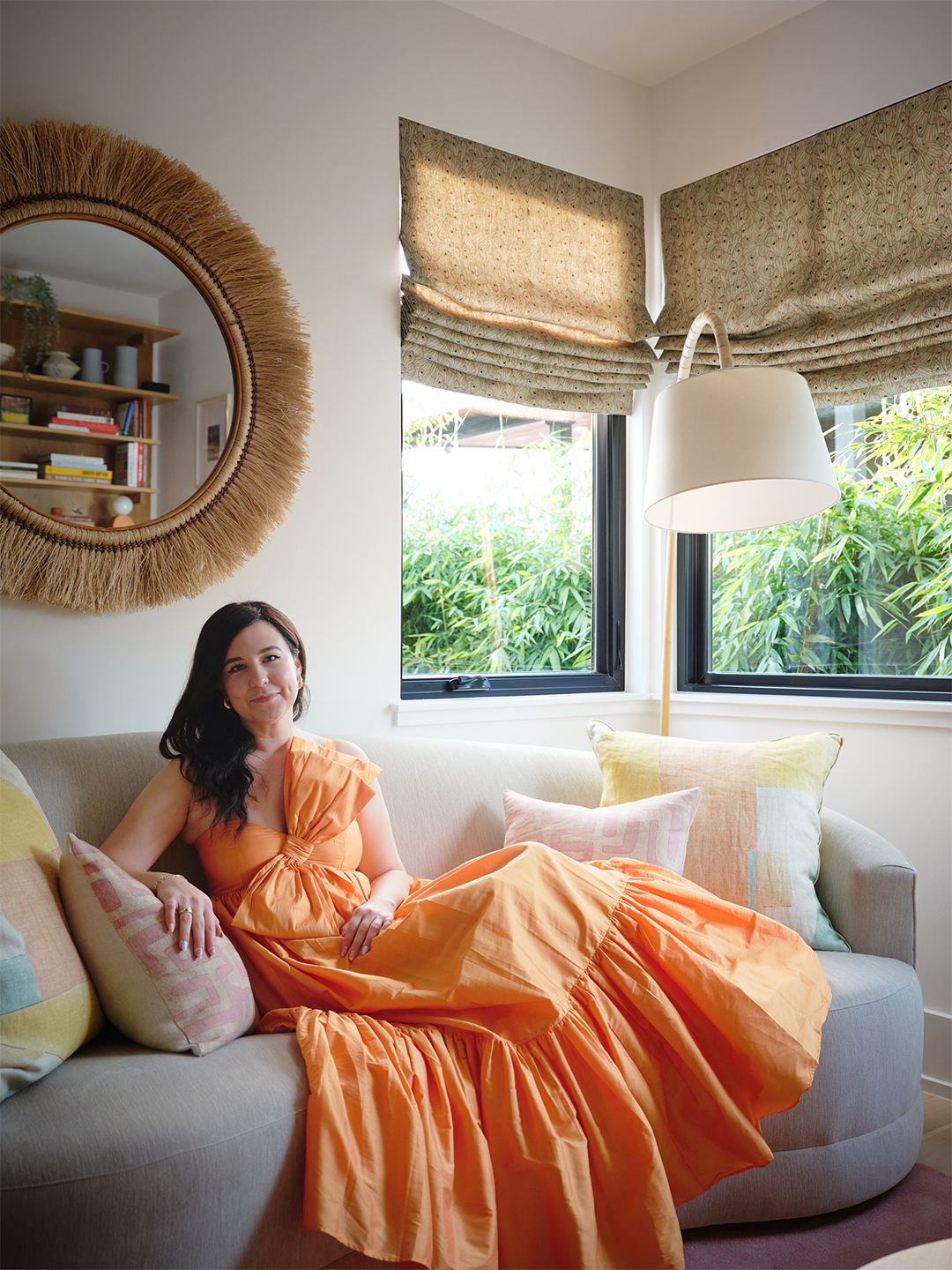 woman in orang dress on sofa