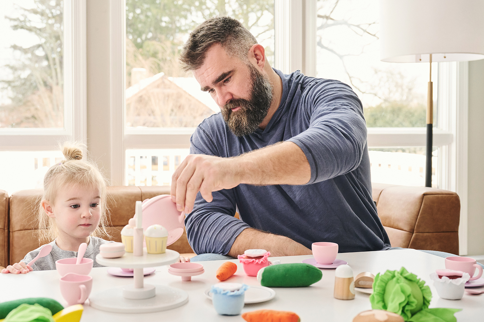 Dad pouring tea for his young daughter