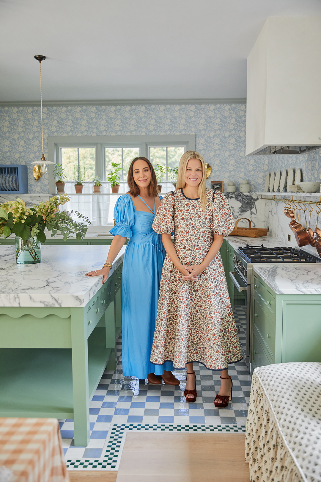 designer and owner standing in kitchen