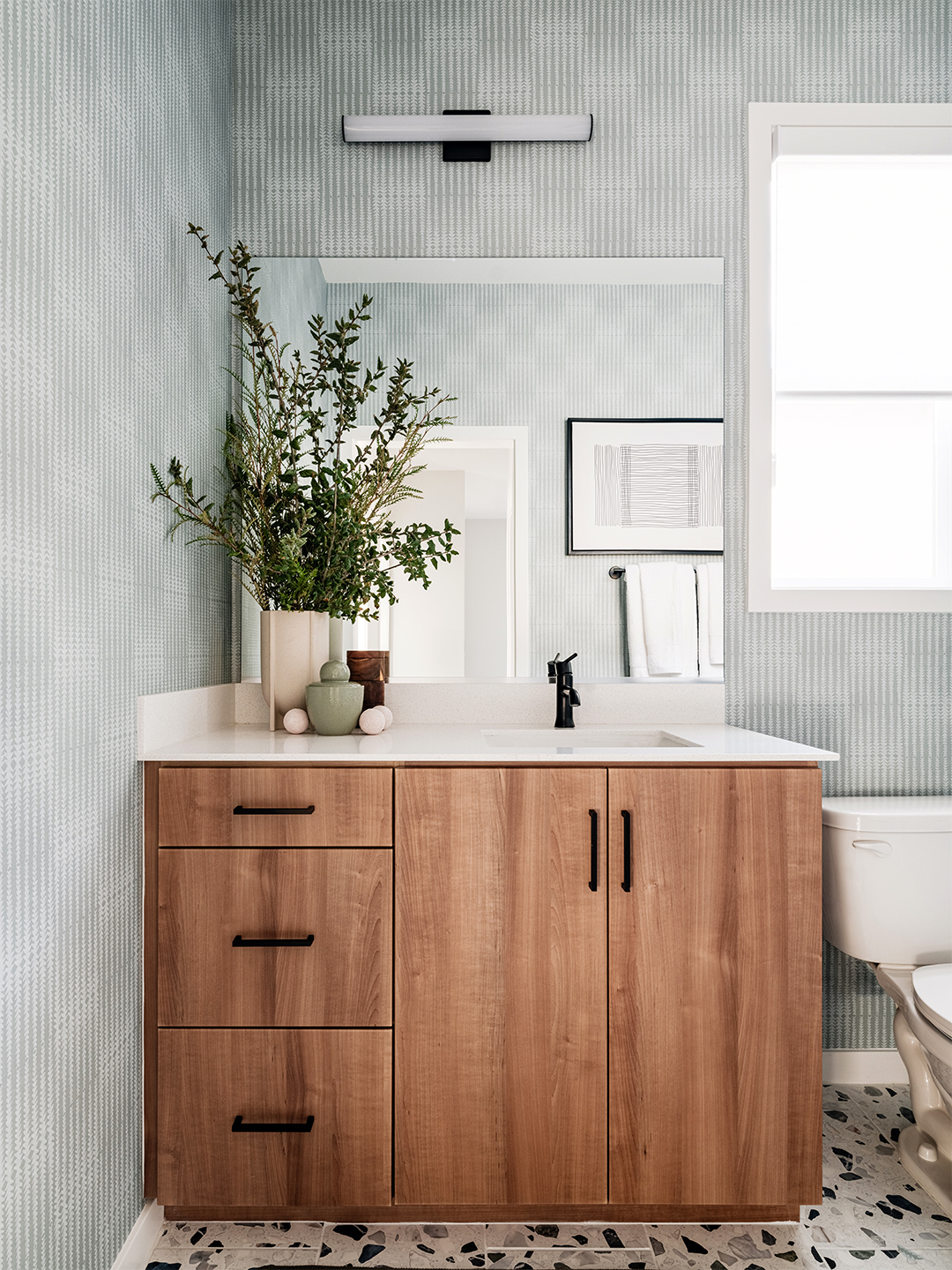 blue bathroom with wood vanity