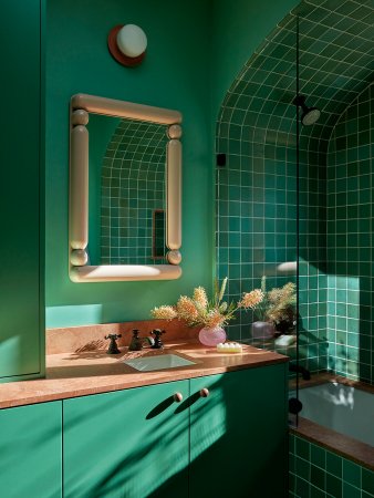 Green bathroom with green tile and cabinets