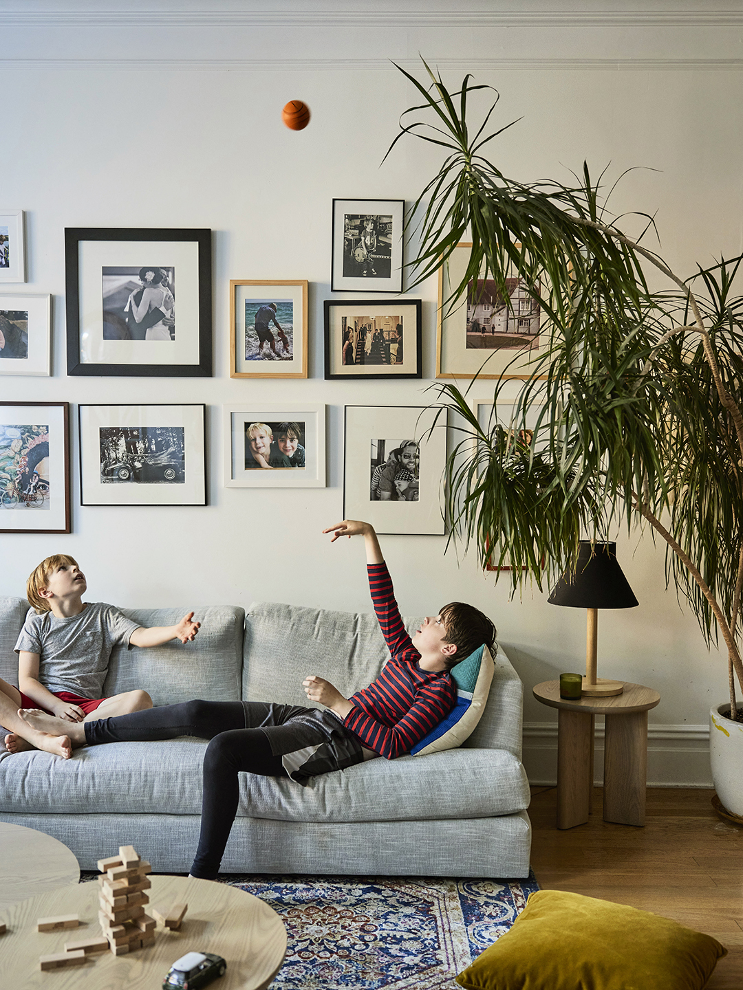 Two preteen boys lounging on a sofa