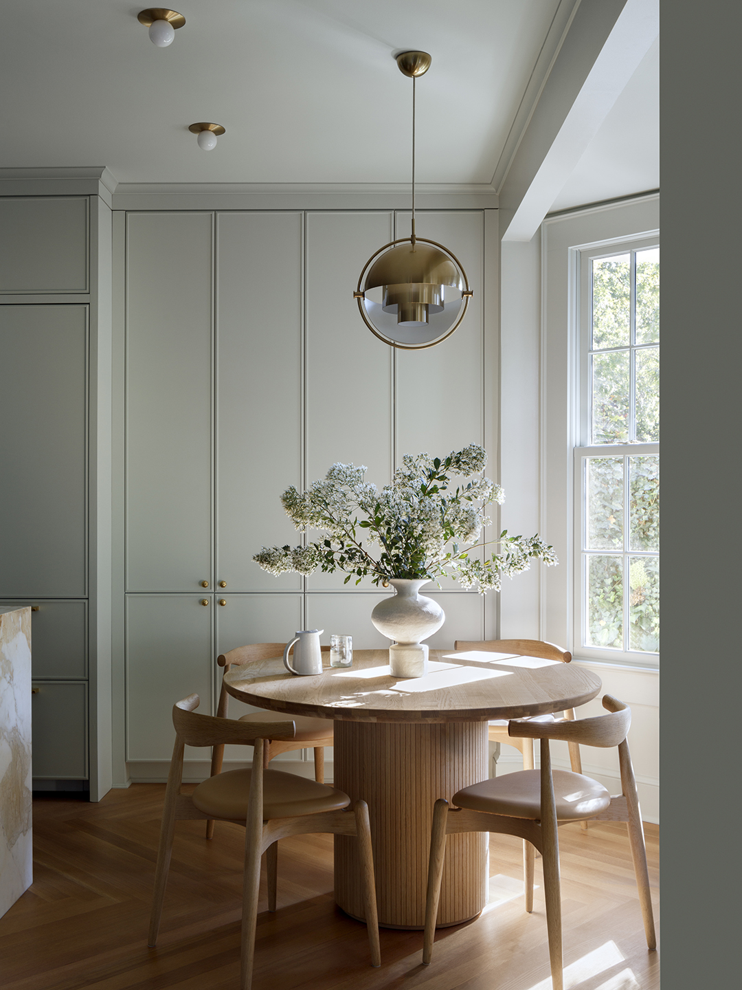 modern brass pendant over dining table