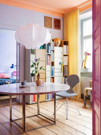 Dining room with yellow curtains and purple walls