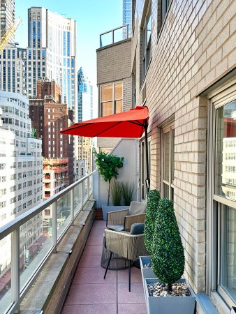 Orange half-circle umbrella on narrow New York City terrace