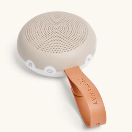  small round white noise machine with strap