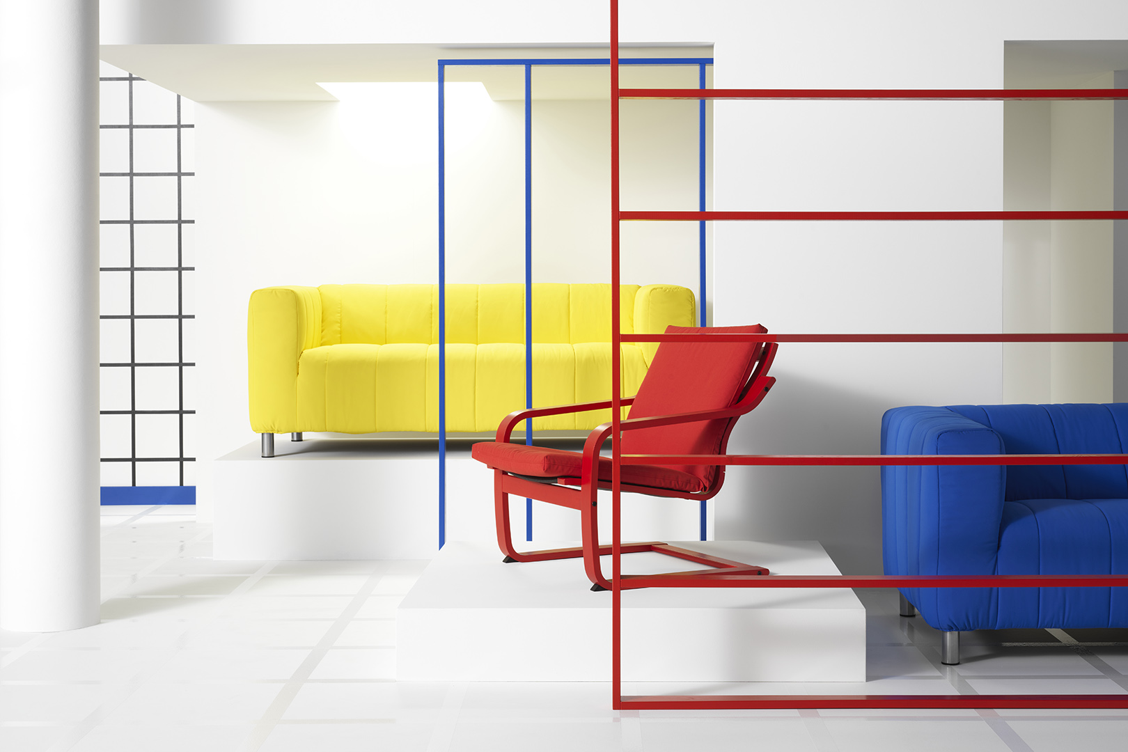 IKEA Klippan sofa in yellow and Poang chair in red