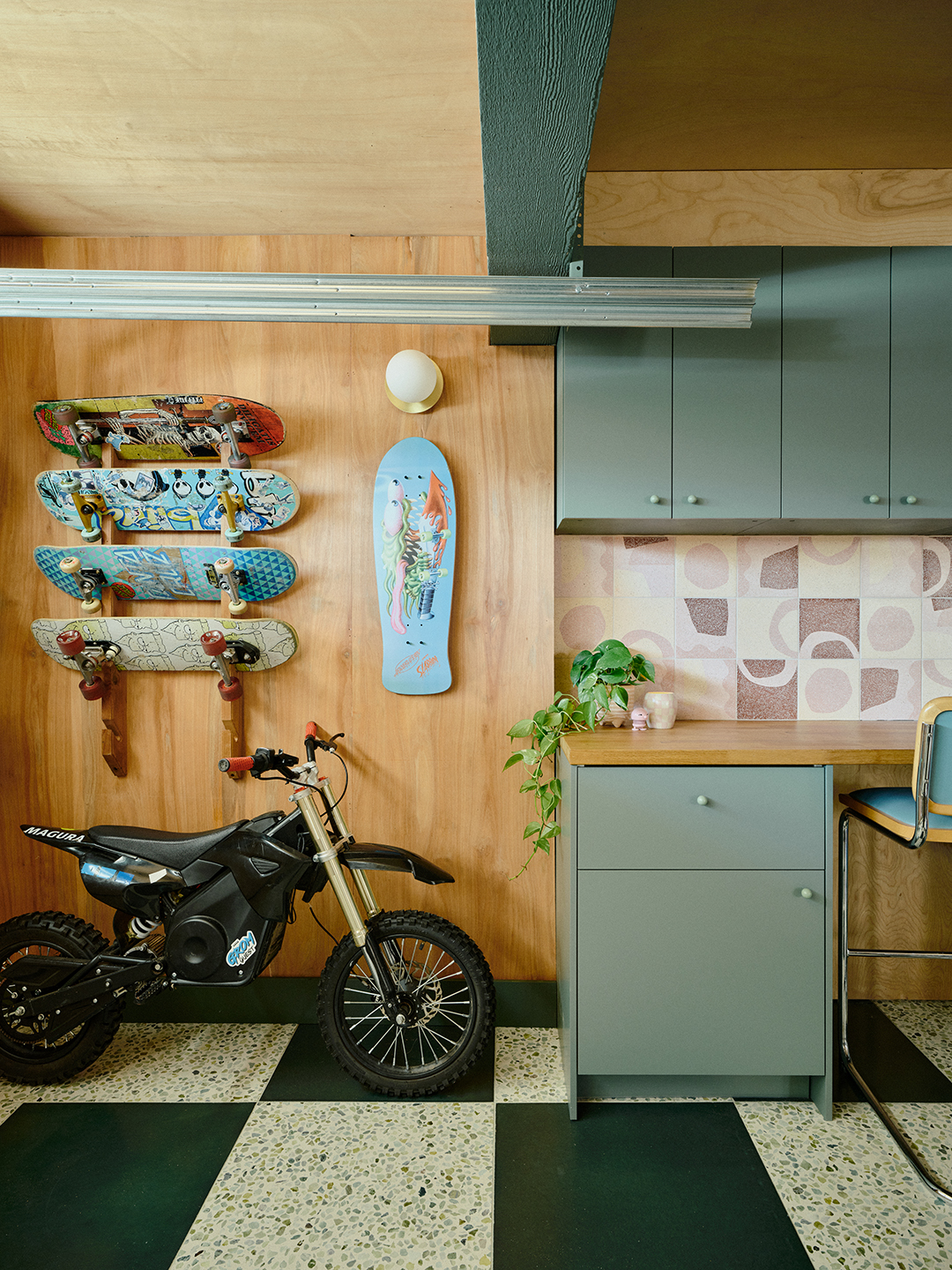 Motorbike parked in a garage and skateboards hanging above