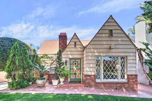 yellow and brick tudor home