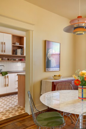 A Galley Kitchen Reno with Retro Cabinets and a Butter Yellow Dining Room