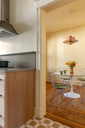 A Galley Kitchen Reno with Retro Cabinets and a Butter Yellow Dining Room