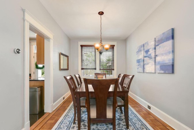 A Galley Kitchen Reno with Retro Cabinets and a Butter Yellow Dining Room