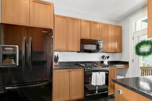 A Galley Kitchen Reno with Retro Cabinets and a Butter Yellow Dining Room