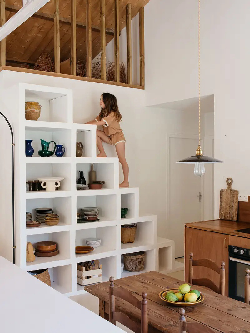 kid climbing up stair shelving