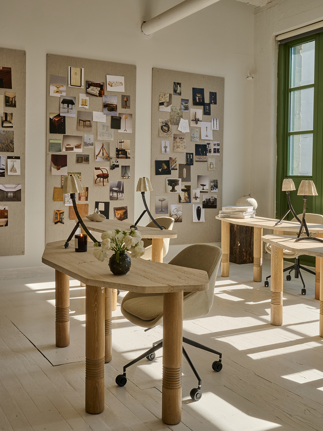 travertine desks next to wall moodboards