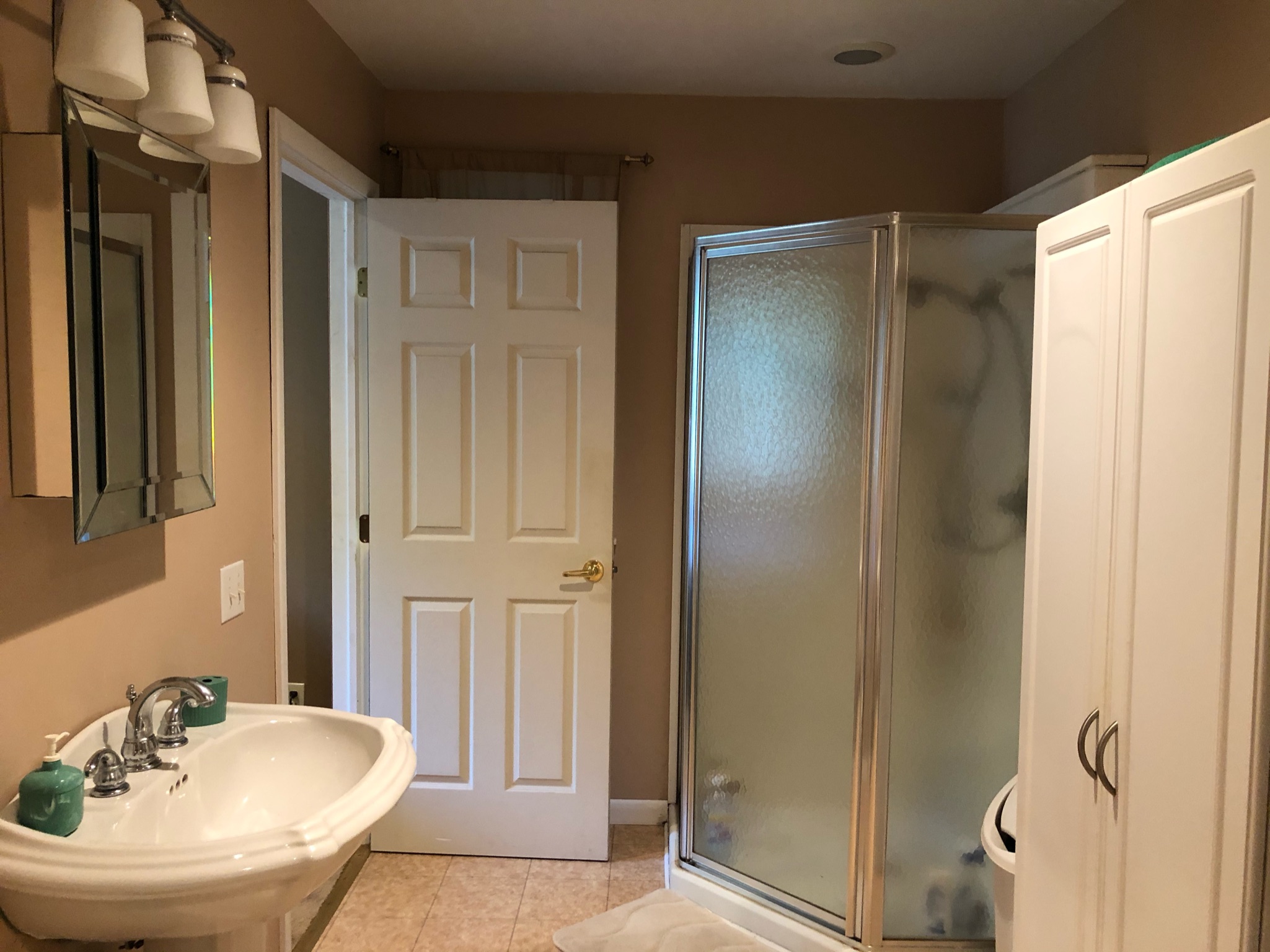 beige bathroom with corner shower