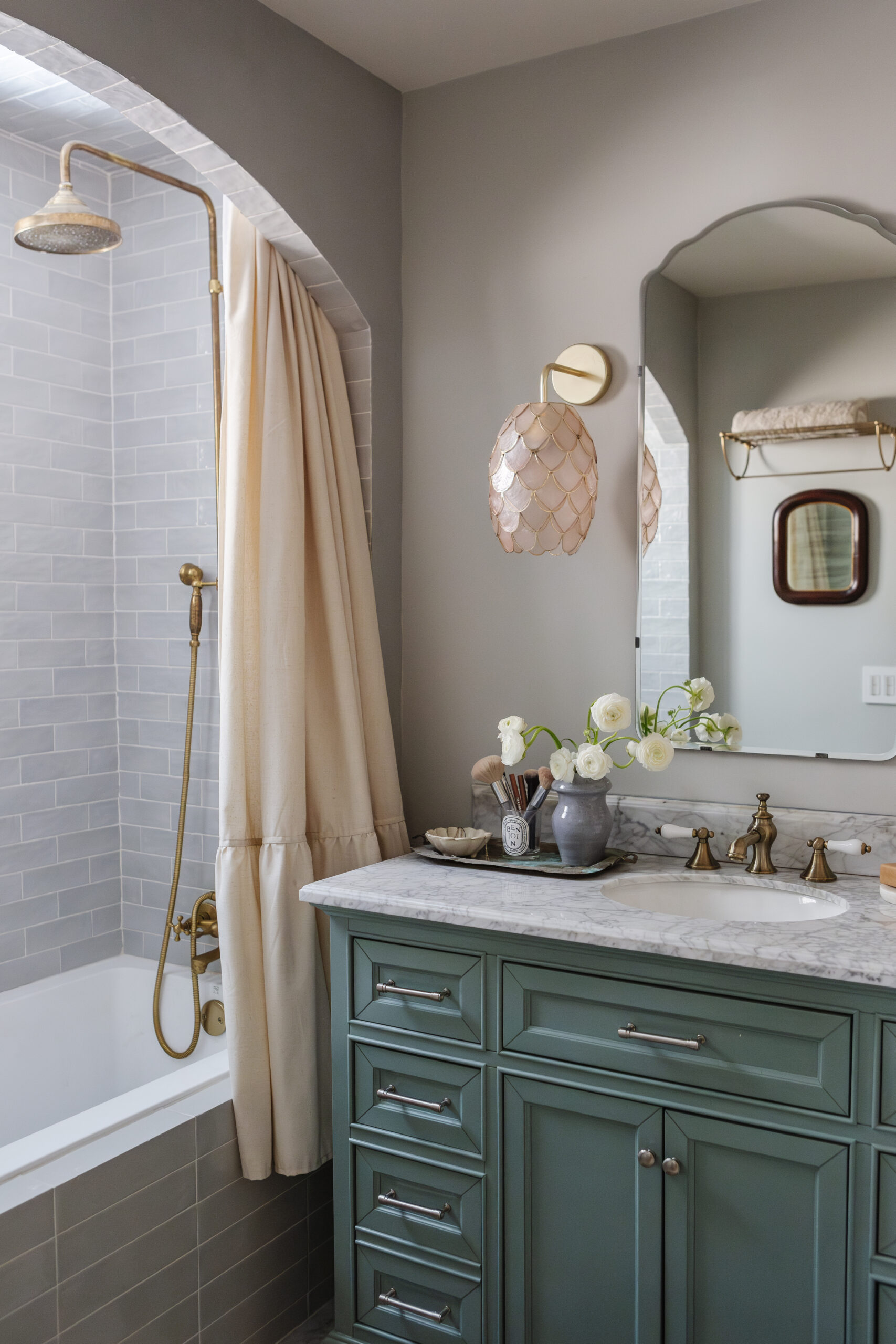 green vanity next to tub