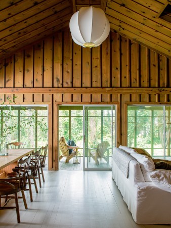 Wood paneled living room leading to patio