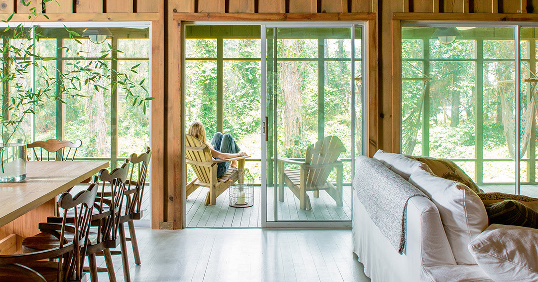 Wood paneled living room leading to patio